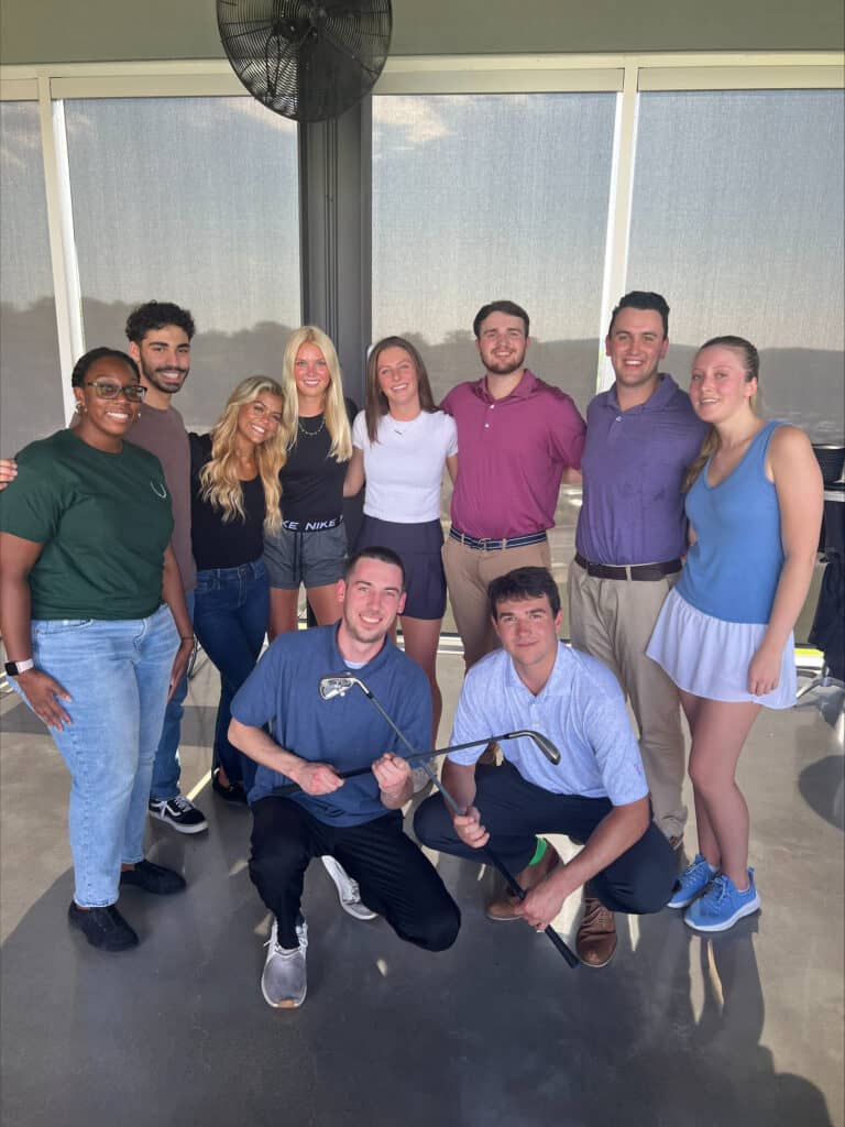 group of summer interns together at top golf