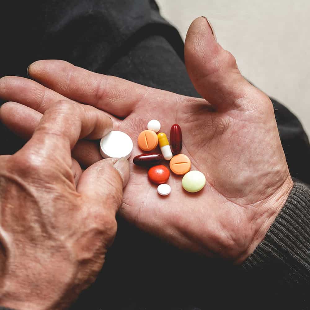 hand holding pharmaceutical pills