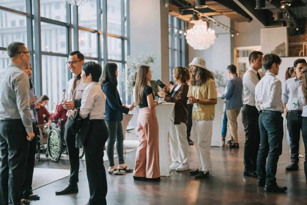 Group of multiracial Asian business participants casual chat after successful conference event