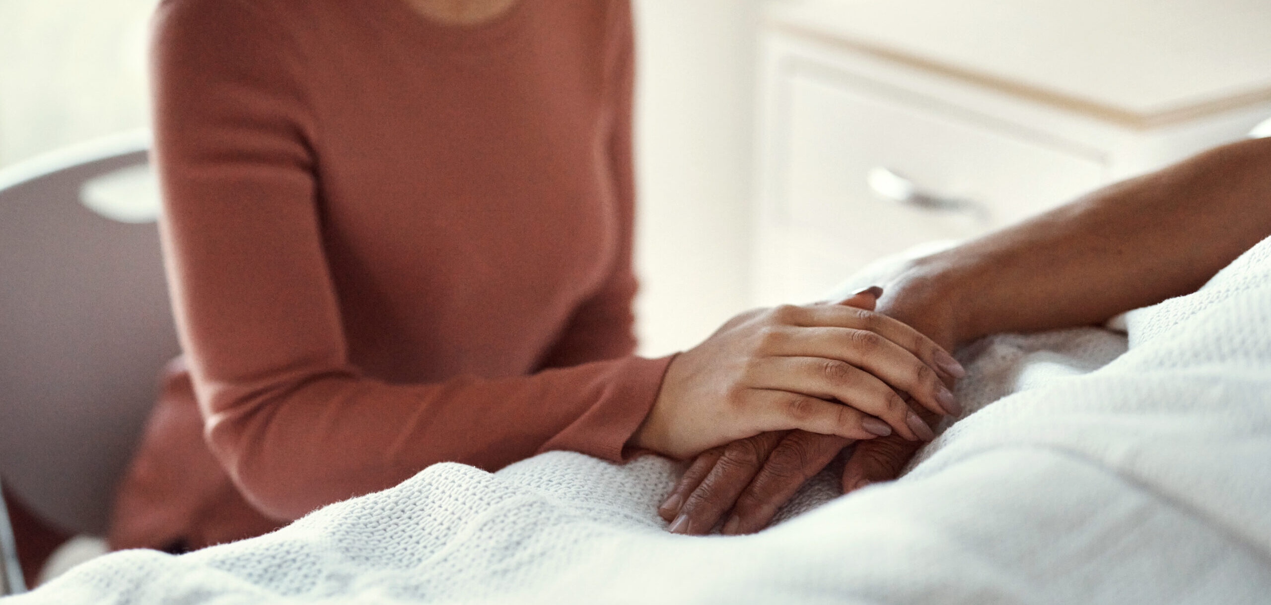 healthcare and support with a woman holding hands with her man in the hospital. Medicine, insurance and trust with a couple in a clinic for treatment or help before death, mourning and loss
