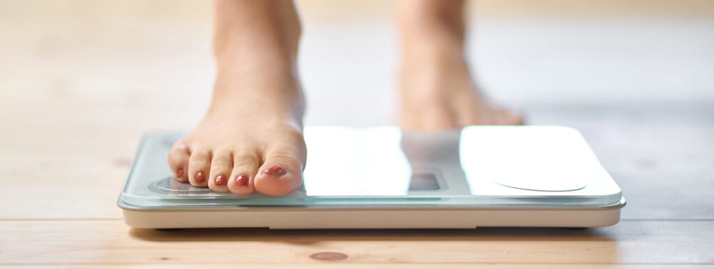 Feet of a woman on a weight scale