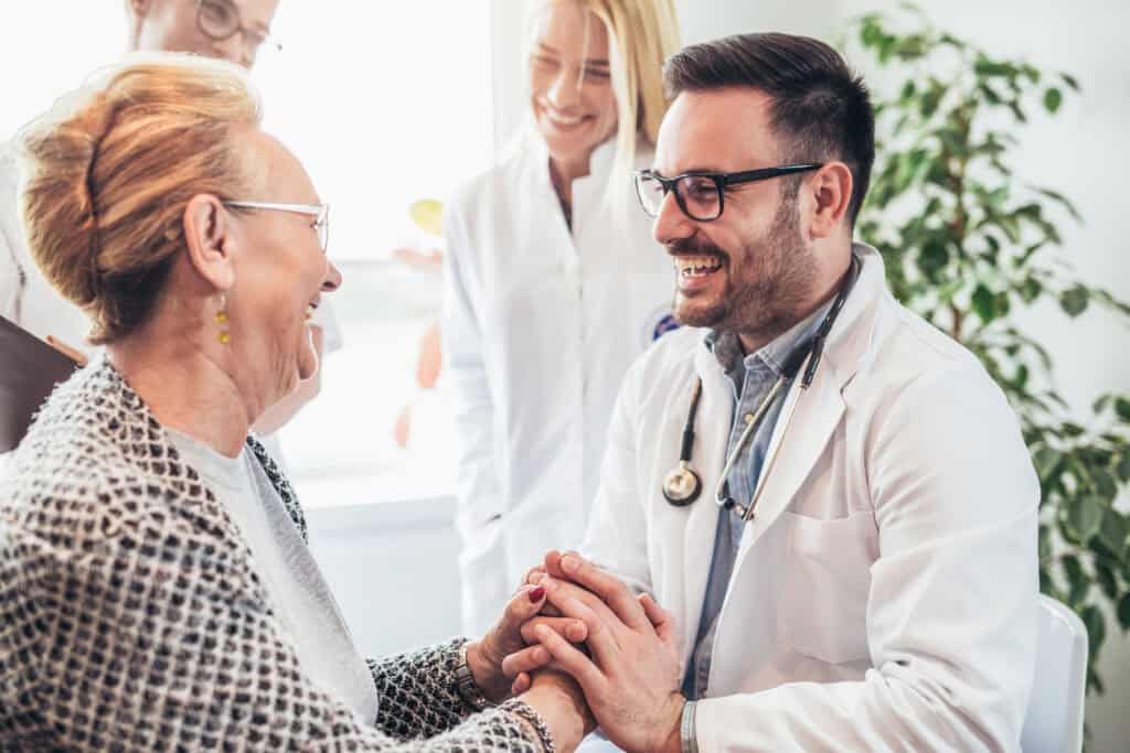 Group of young doctor during home visit senior people