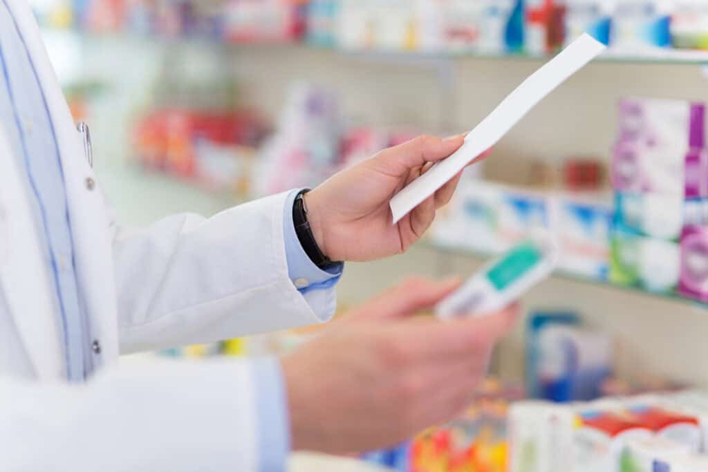 Pharmacist filling prescription in pharmacy