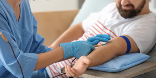 Man donating blood in hospital