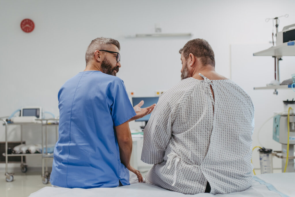 Male doctor having consult with male obese patient